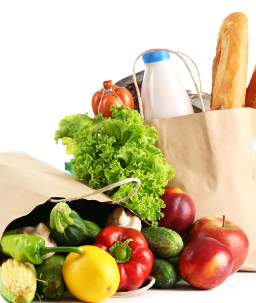 A bag of food with vegetables and bread on the side.