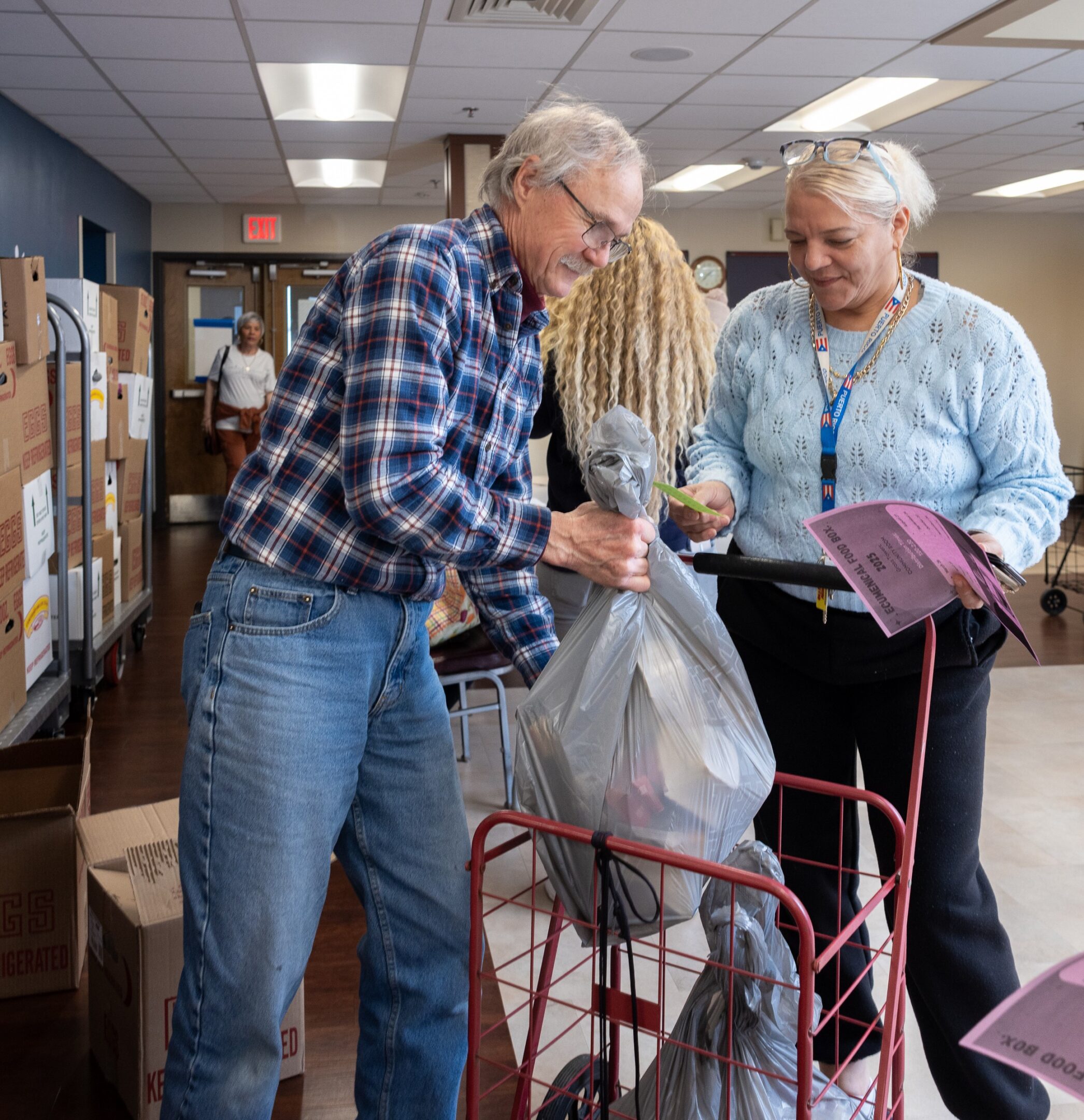 Elderly Photo A man and woman looking at items in a bag.