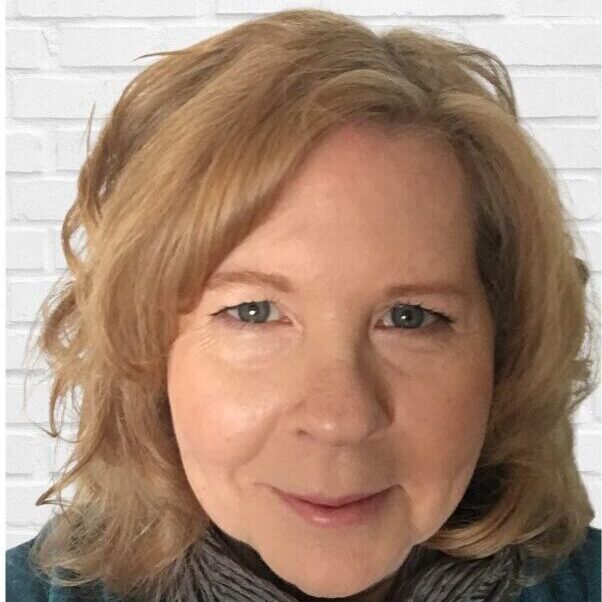 OUR TEAM Anne Egan Headshot A woman with blonde hair and blue eyes.